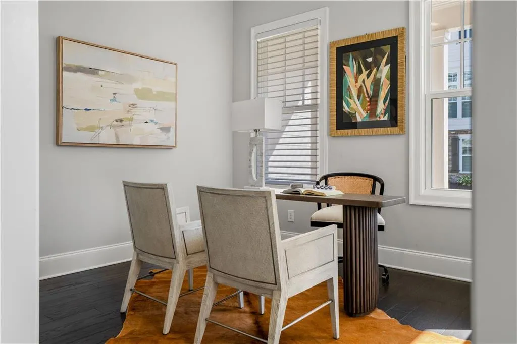 Home office featuring wood finished floors, baseboards, and plenty of natural light