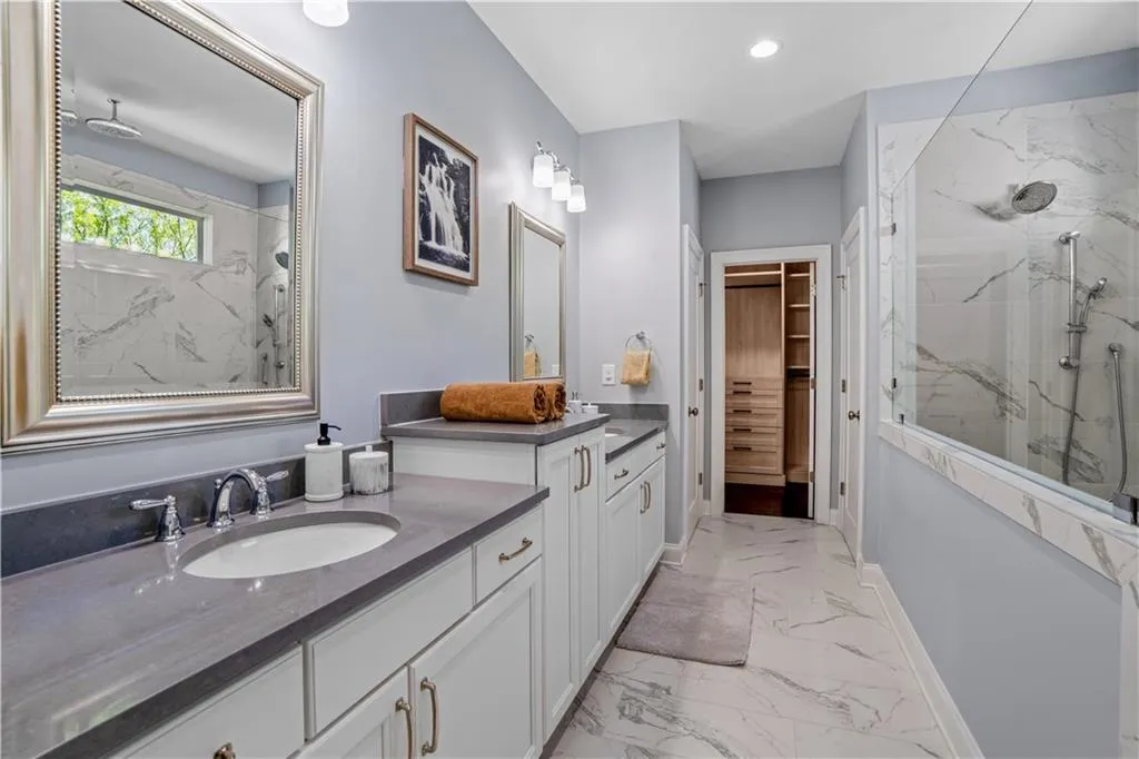 Full bathroom with vanity, baseboards, recessed lighting, a marble finish shower, and marble finish floor