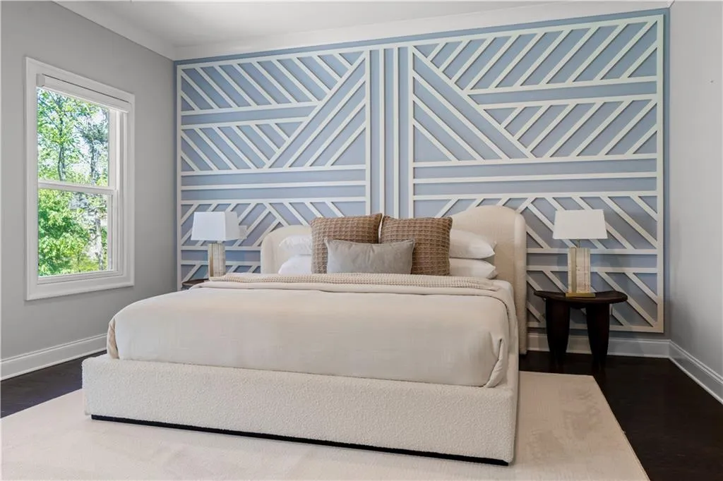 Bedroom featuring ornamental molding, baseboards, and dark wood finished floors
