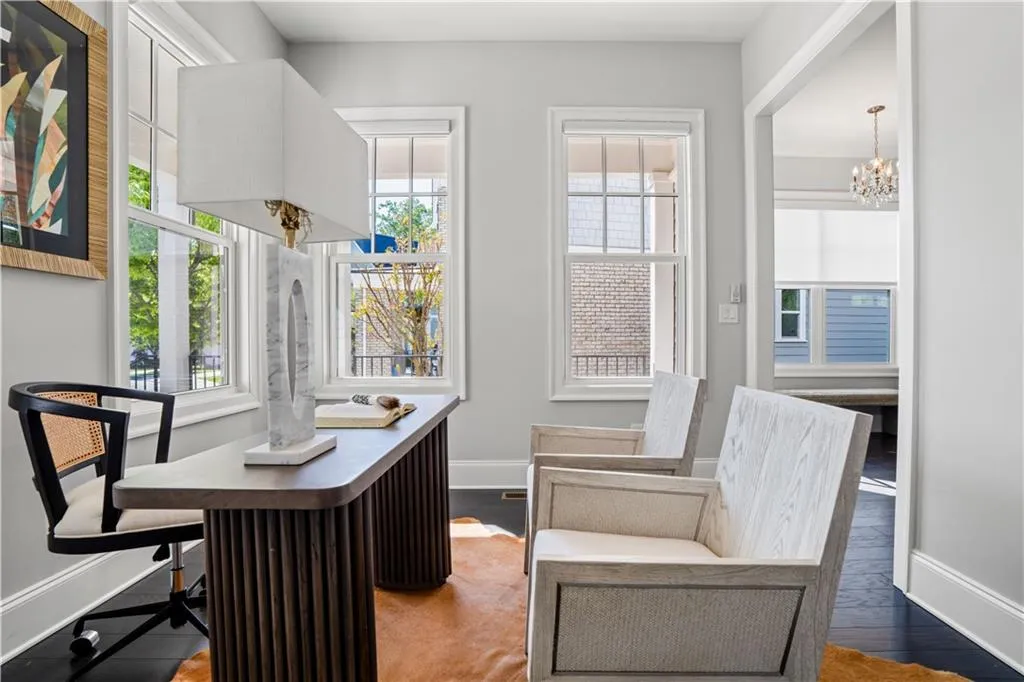 Office with a chandelier, baseboards, wood finished floors, and a healthy amount of sunlight