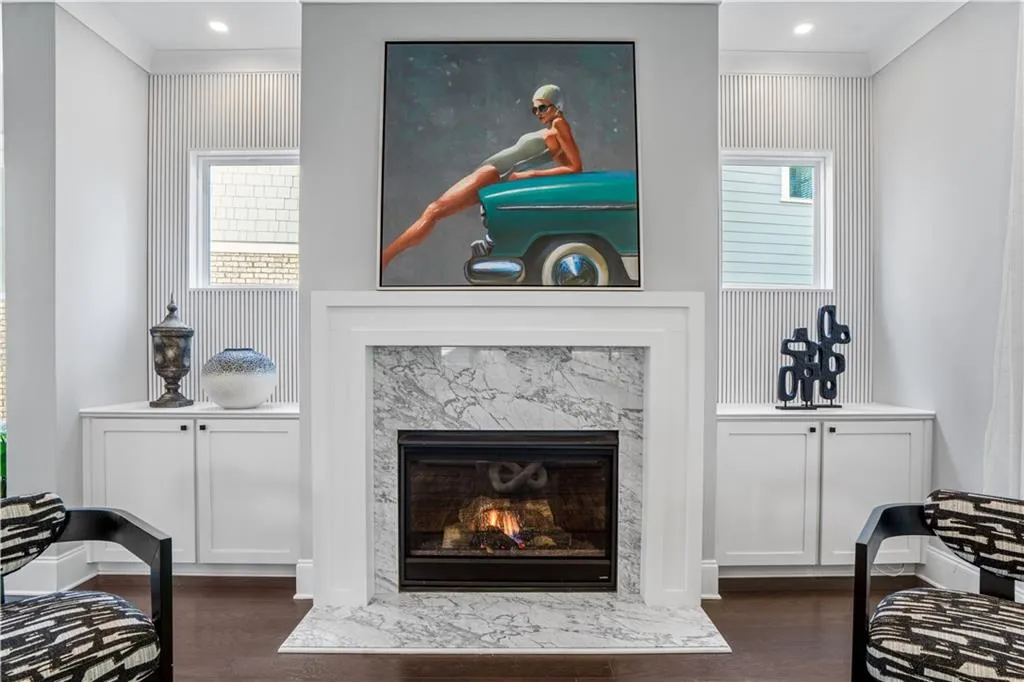 Living room featuring a high end fireplace, dark wood-style floors, and recessed lighting