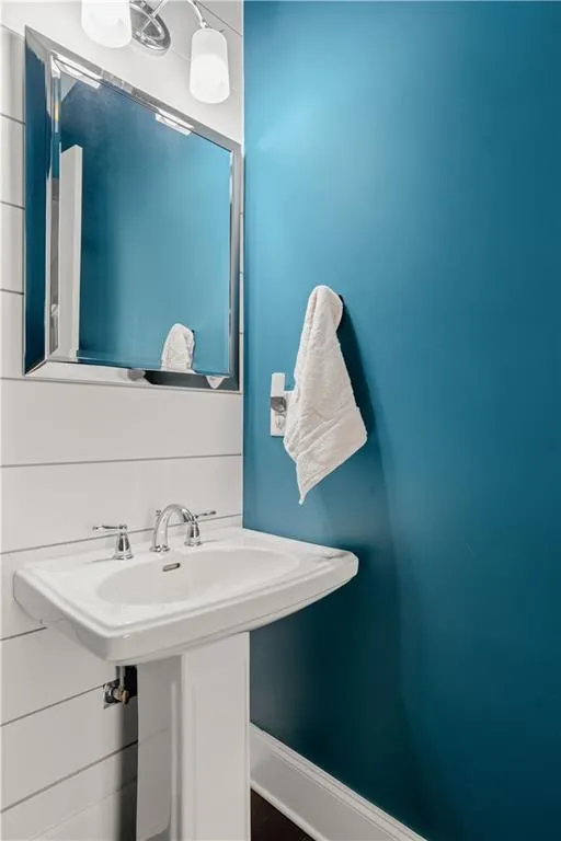 Bathroom with a sink and baseboards