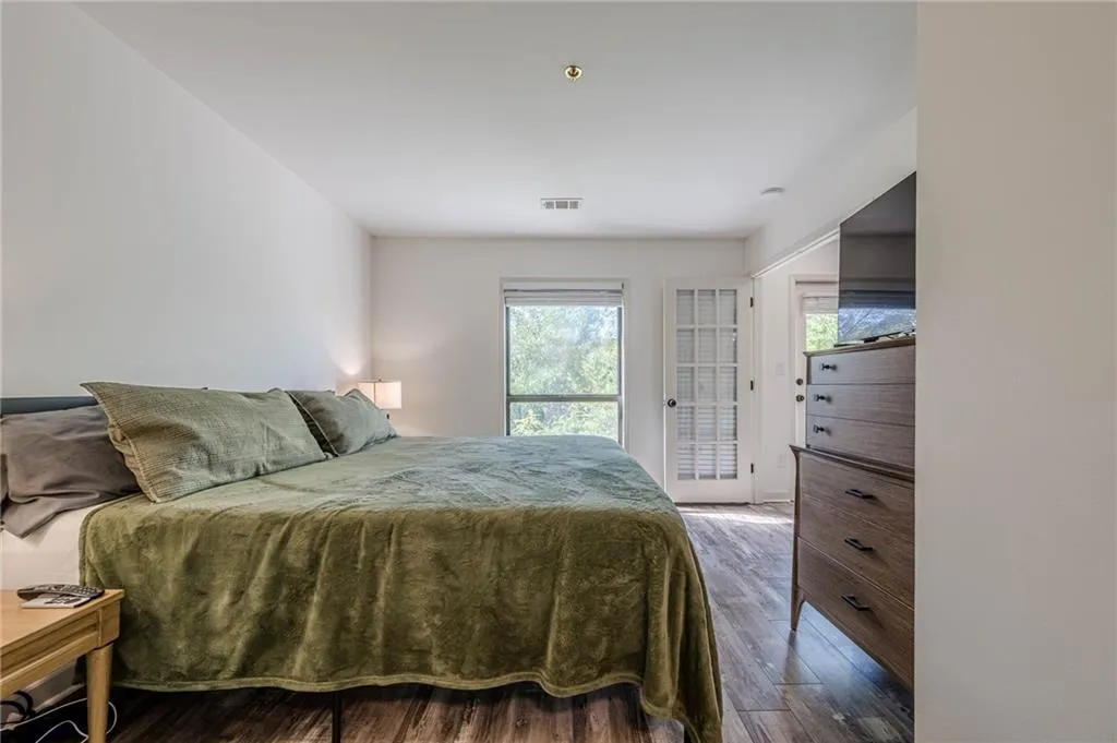 Bedroom with wood finished floors and access to exterior