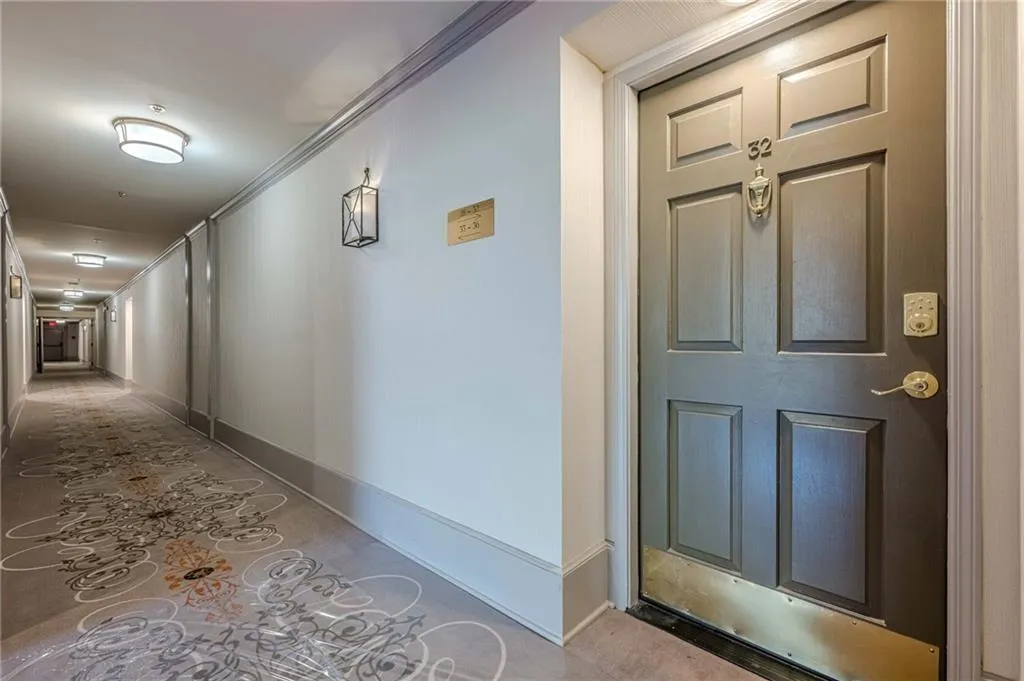 Hall featuring crown molding and baseboards