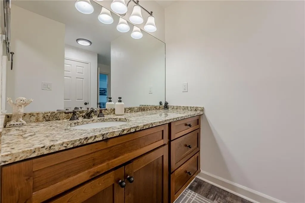 Bathroom with vanity and dark wood-style flooring