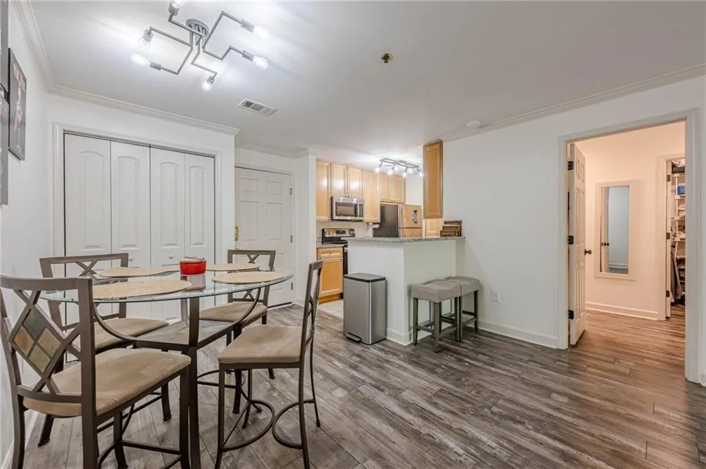 Dining room featuring ornamental molding and dark wood finished floors