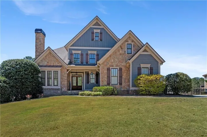 Elegant curb appeal highlighted by detailed stonework, charming shutters, and a covered front porch. The manicured lawn and mature landscaping create a warm and inviting first impression. Located in the desirable Bluff’s section of Bentwater with access to community amenities and optional golf club membership.