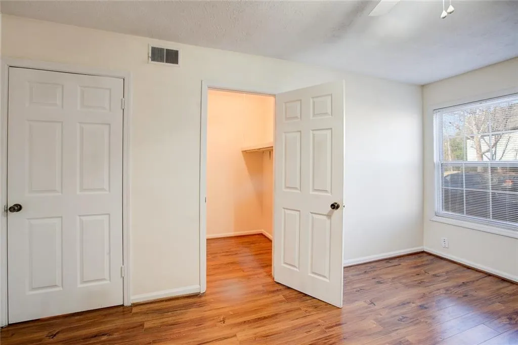 Unfurnished bedroom featuring a closet, ceiling fan, and light wood-type flooring