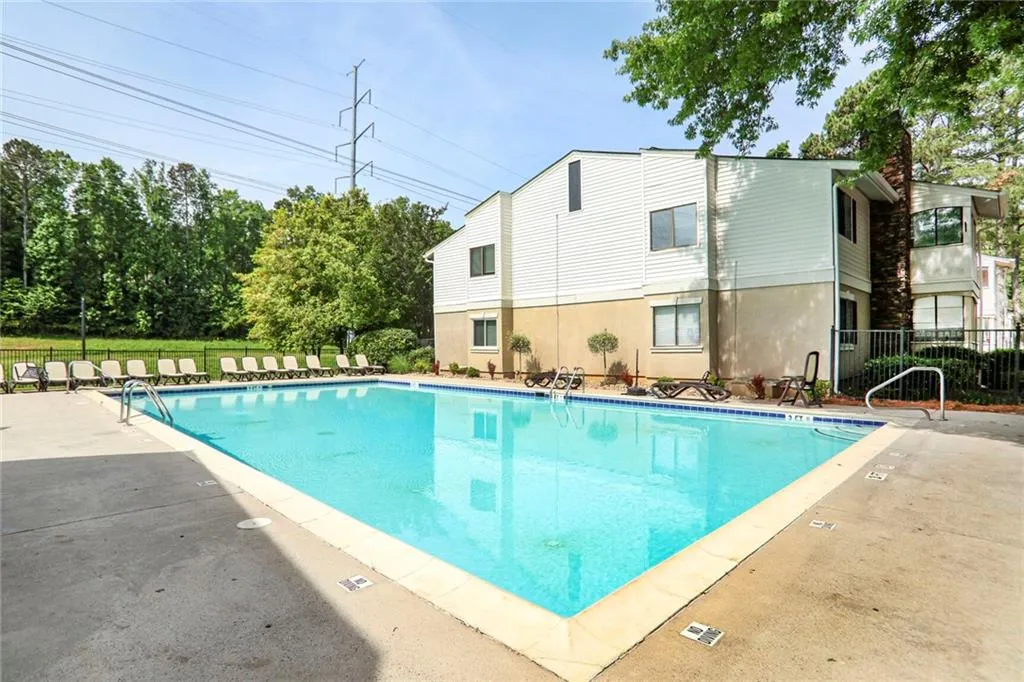 Community pool with fence and a patio