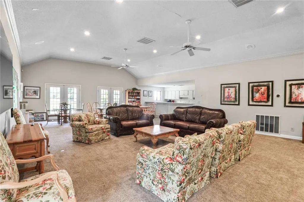 Clubhouse with kitchen, vaulted ceiling, a ceiling fan, french doors, and recessed lighting. Clubhouse is getting a refresh!