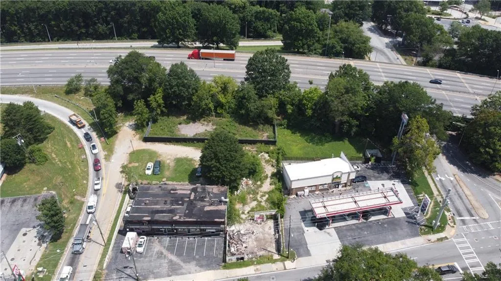 Commercial property featuring two structures, paved parking areas, and frontage on a public road