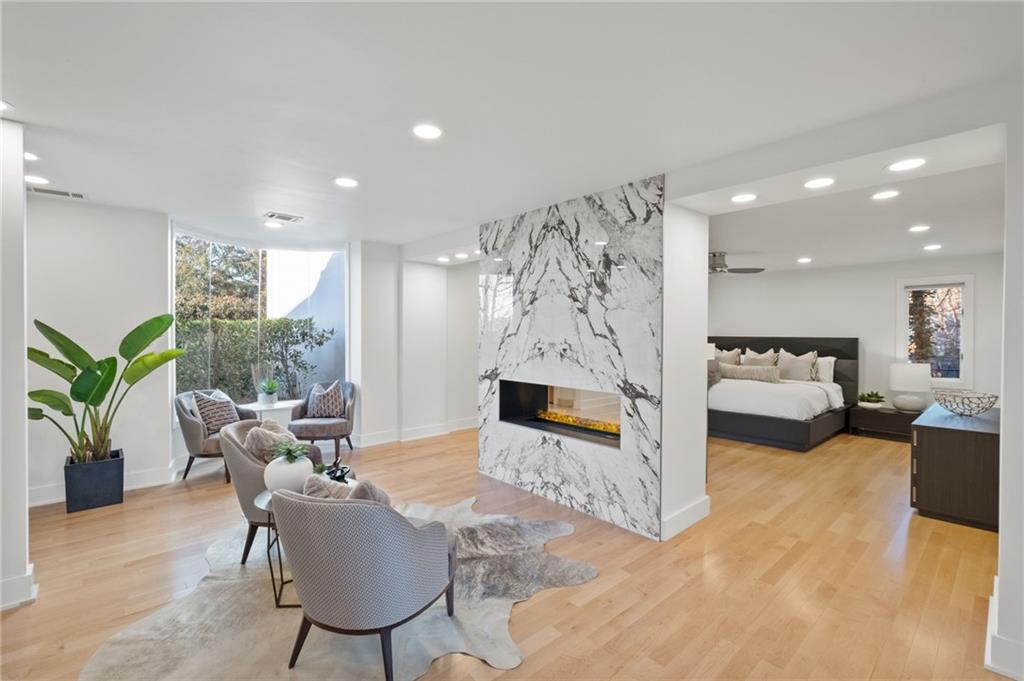 Seating area in owners suite with double sided fireplace