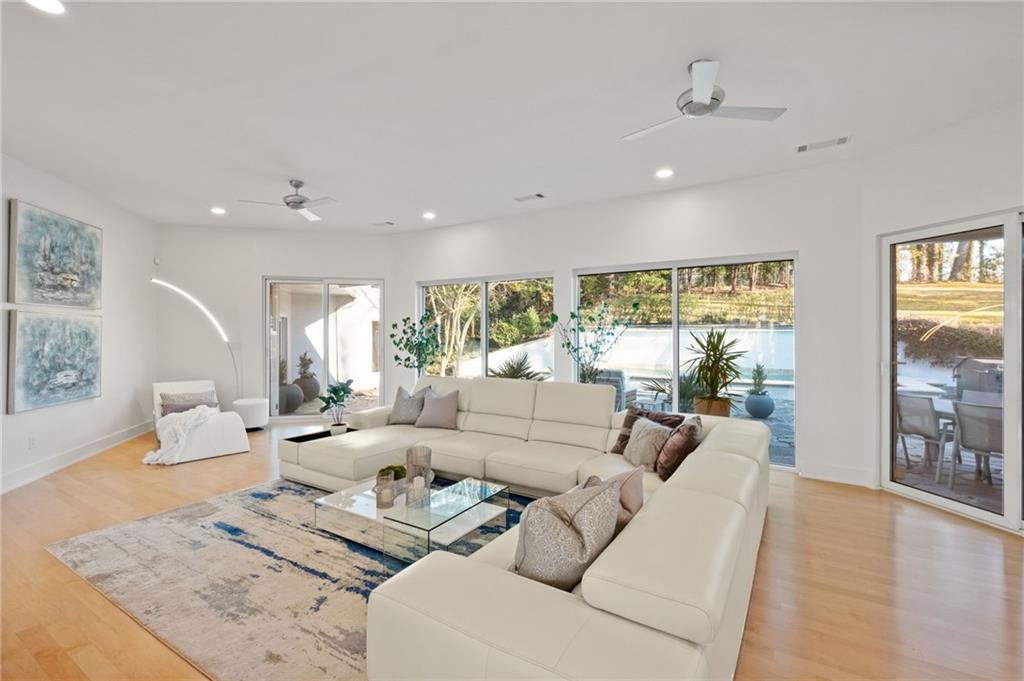 Great room with view and access to pool and patio