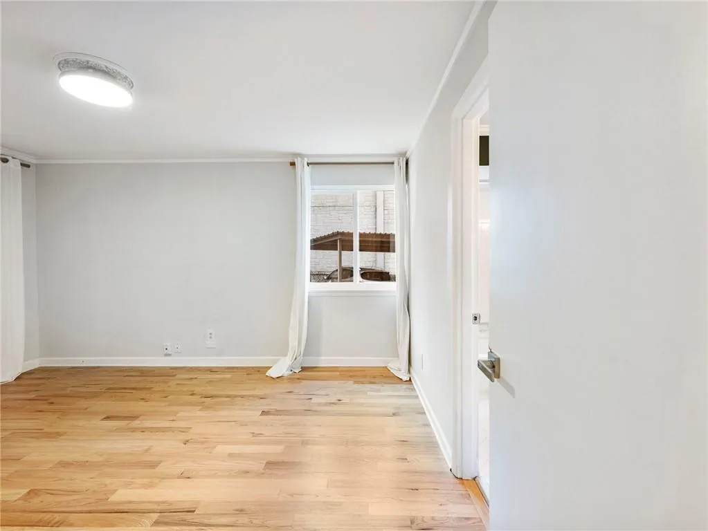 Empty room featuring light wood-style flooring and baseboards