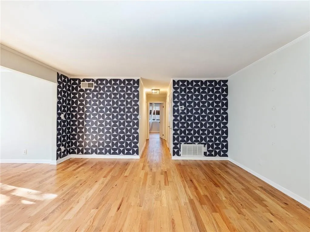 Empty room with wood finished floors and baseboards