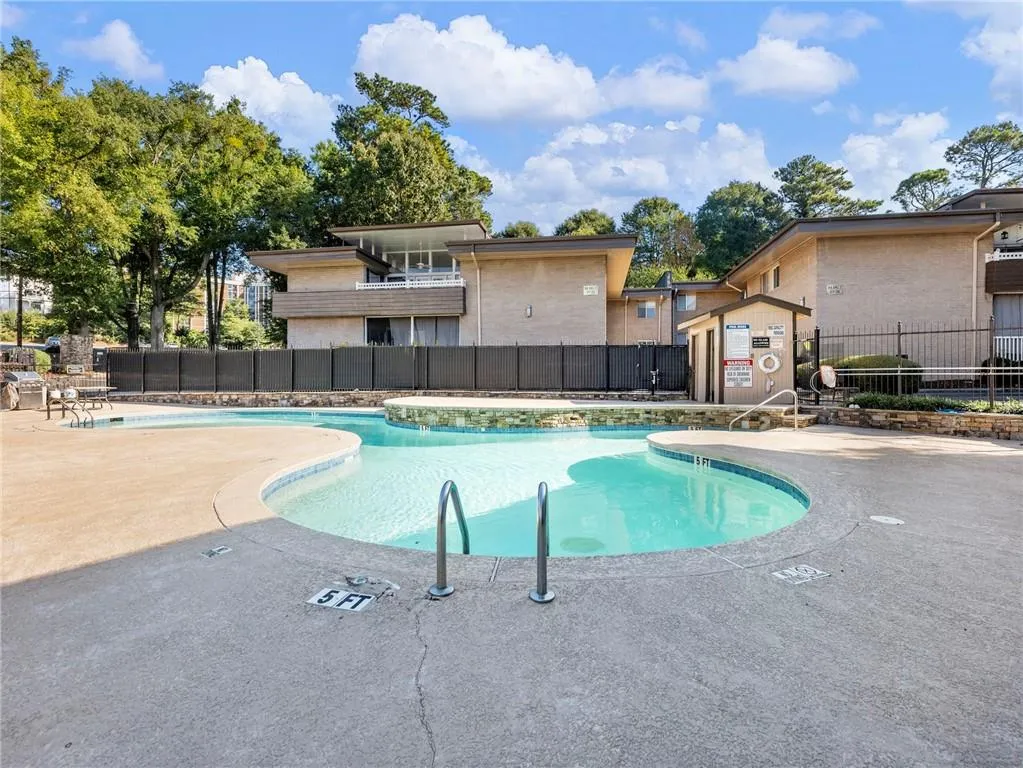 Community pool with a patio