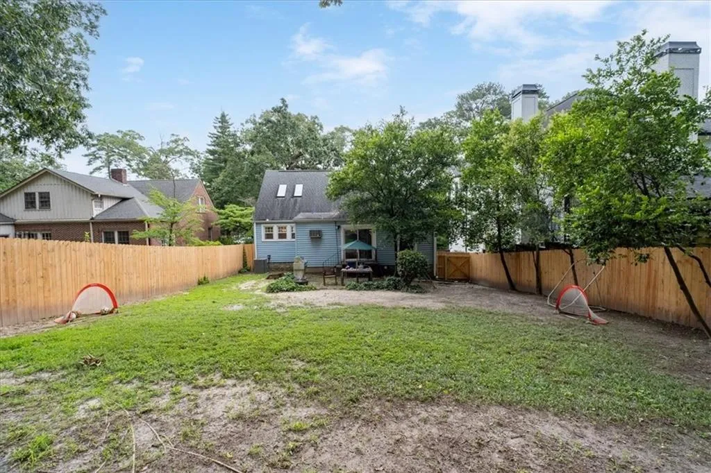 Rear view of property featuring a fenced backyard and a patio area