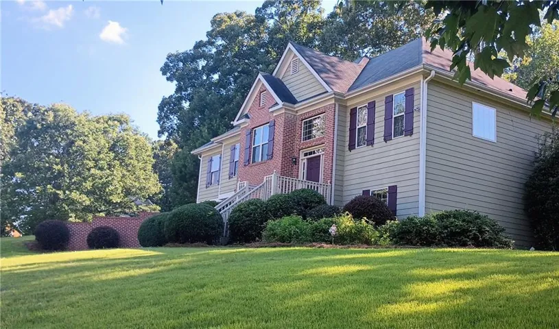 Classic grandeur, striking curb appeal, and lush mature landscaping on a large corner lot!