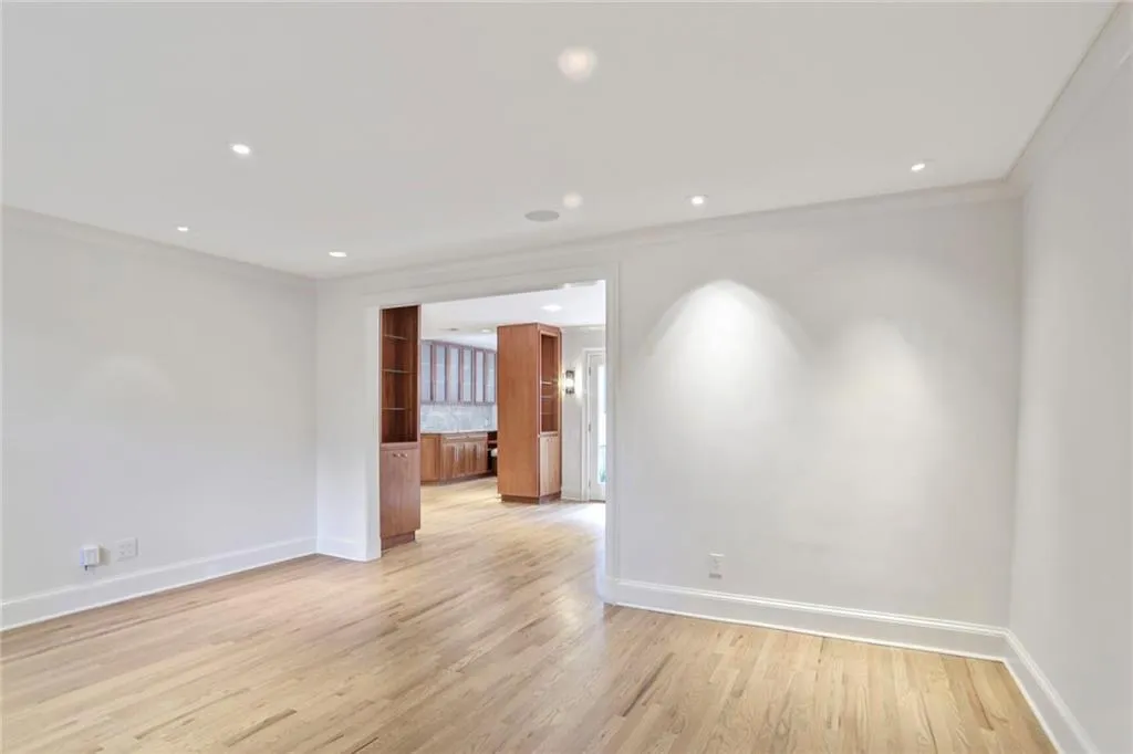 Empty room with crown molding, light wood-style floors, and recessed lighting