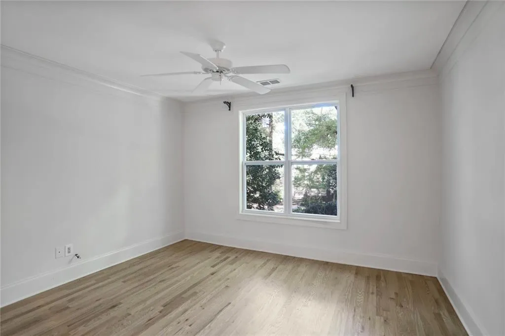 Empty room featuring light wood-style flooring and ceiling fan