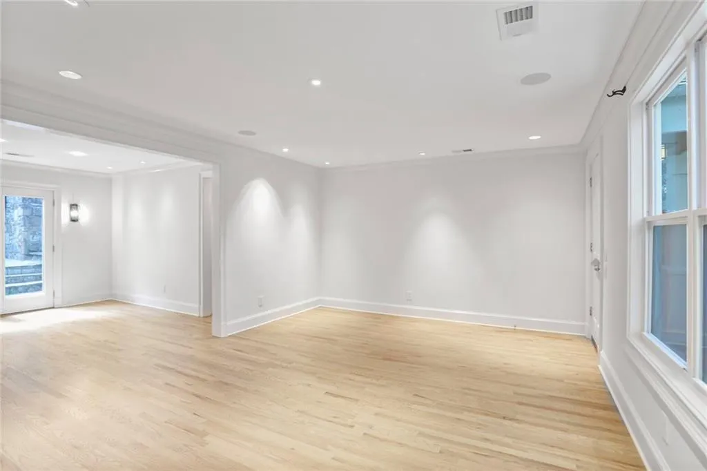 Spare room featuring crown molding, light wood-type flooring, and recessed lighting