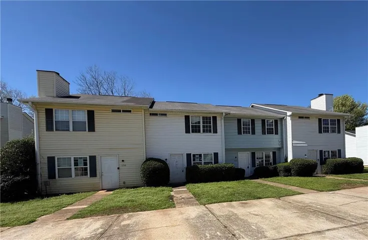 View of front of home with a chimney and a front lawn
