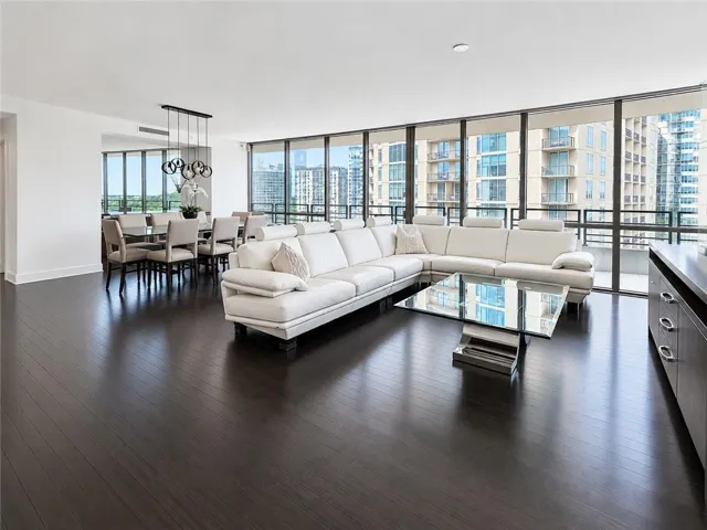 Open-concept living space with dark wood-finish flooring