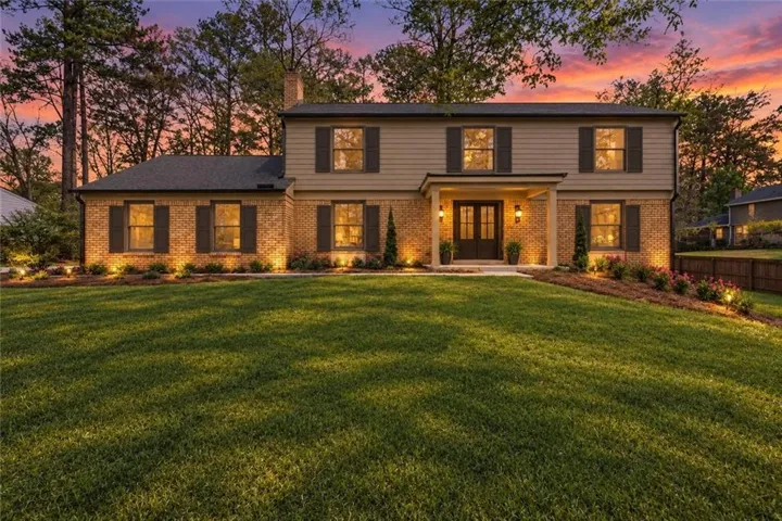 Beautifully renovated traditional home, double entry front doors, covered porch, and established landscaping on large Fox Hills lot