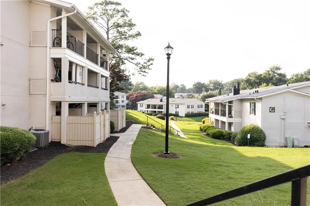 Multi-story building exterior featuring private balconies and patios