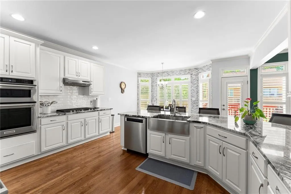 Newly Updated Kitchen with White Cabinets and Granite Countertops
