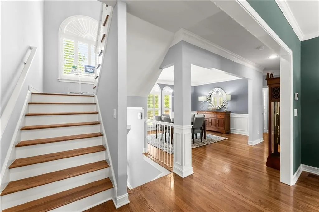 Stairs with view of dining room