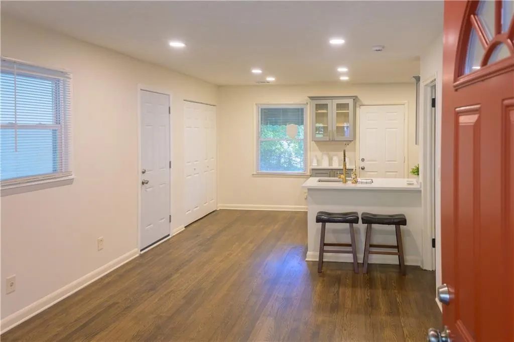 Entryway with dark wood-type flooring and recessed lighting