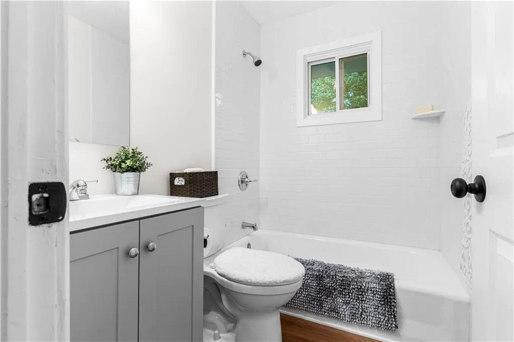 Full bathroom featuring shower / bathtub combination, vanity, and wood finished floors