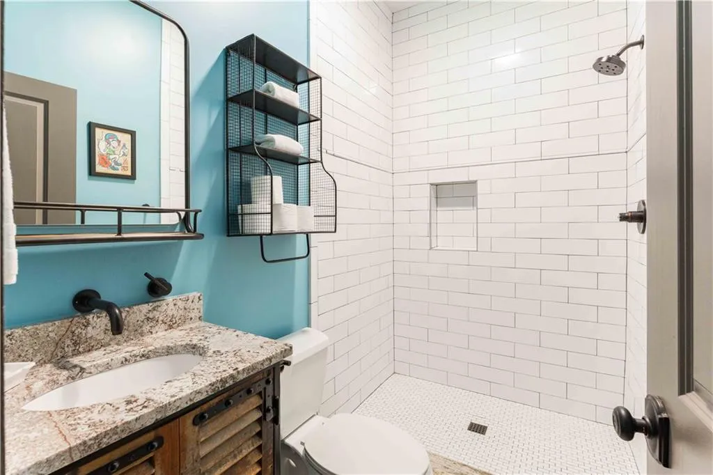Bathroom featuring a shower stall and vanity