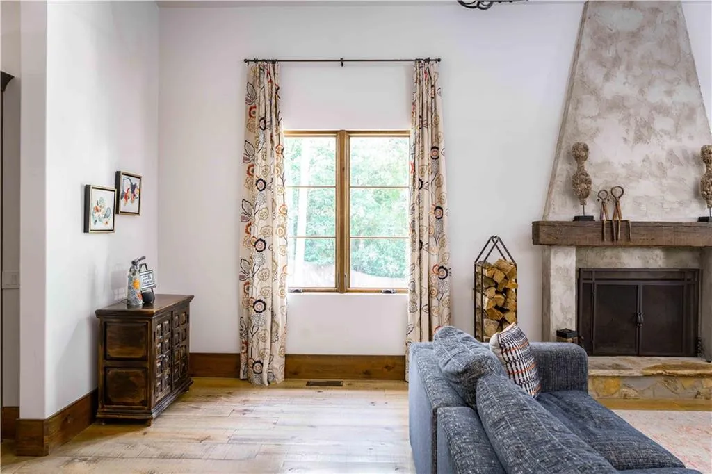 Living area with hardwood / wood-style flooring and a premium fireplace