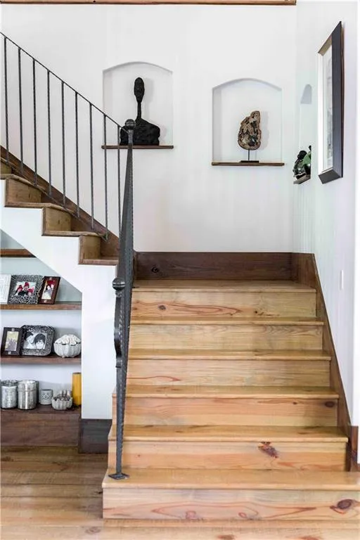 Staircase featuring wood finished floors