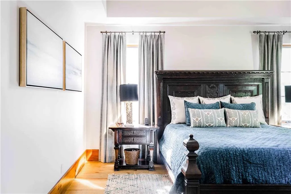 Bedroom with wood finished floors and baseboards