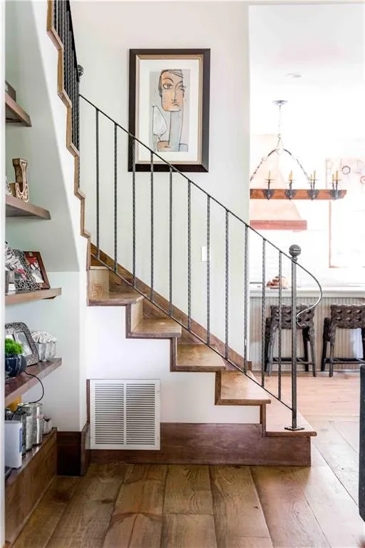 Stairs featuring hardwood / wood-style flooring