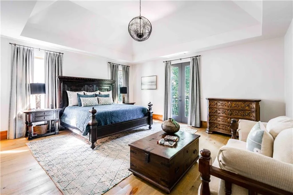 Bedroom featuring a raised ceiling and light wood-style flooring