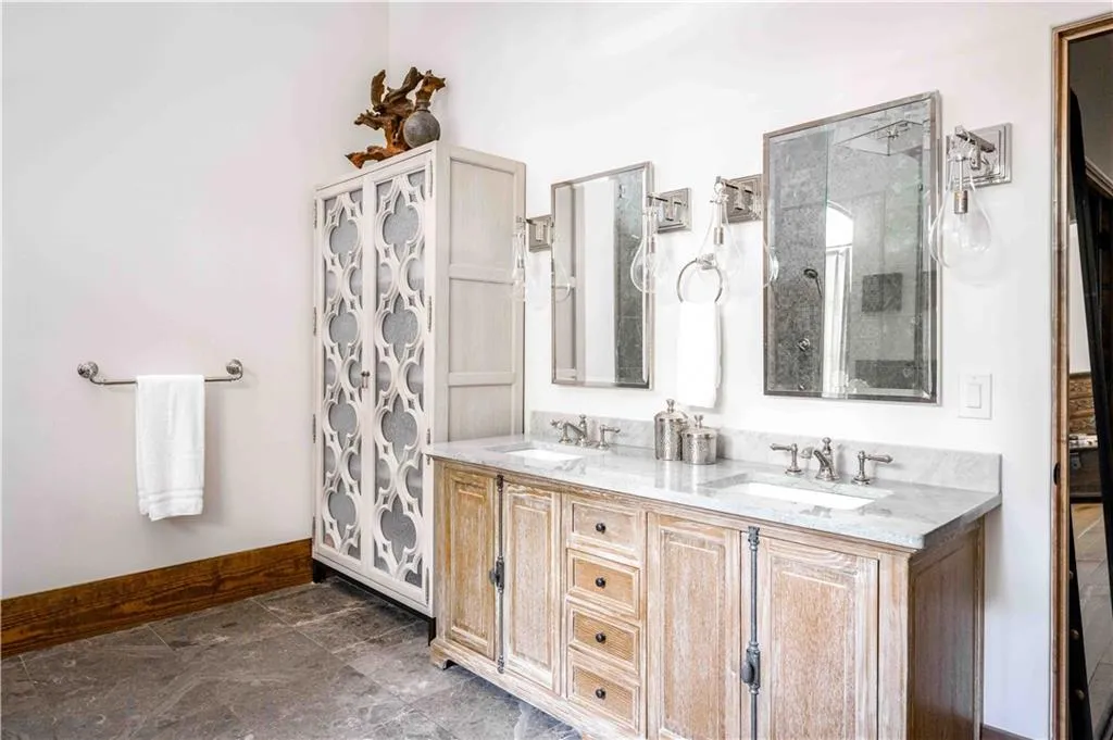 Full bath featuring double vanity and a shower with curtain
