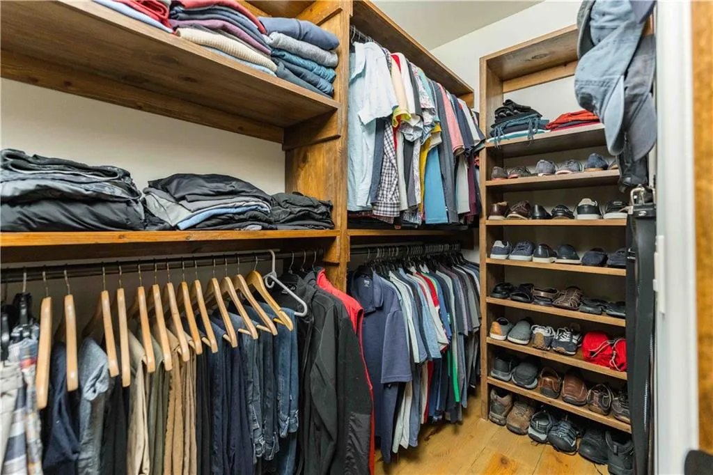 Spacious closet with light wood finished floors