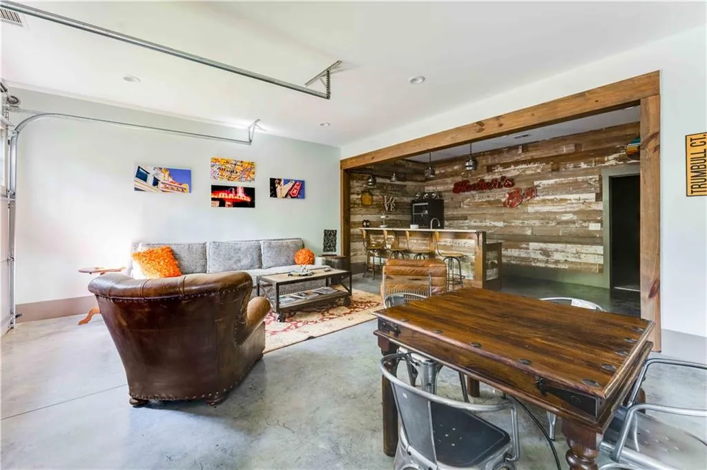 Living area with wood walls, concrete floors, and a garage