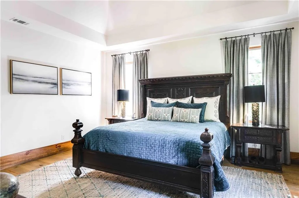 Bedroom with wood finished floors and baseboards