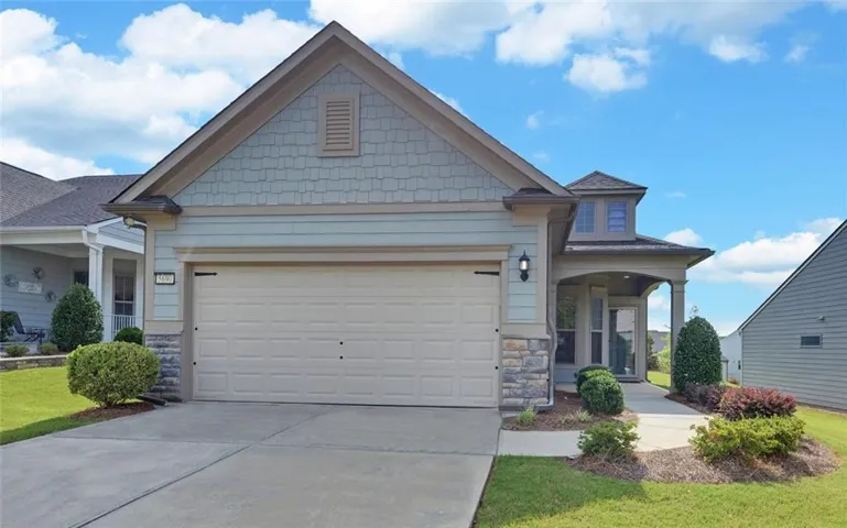 Exterior featuring a covered entryway, stone accents, and a two-car garage