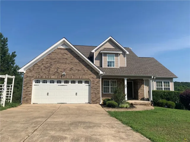 Brick and siding exterior with a covered entry