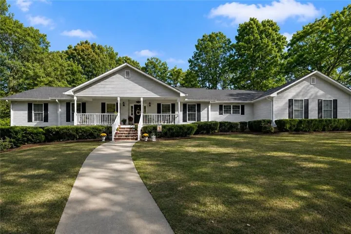 Ranch-style exterior with a covered front porch and white siding