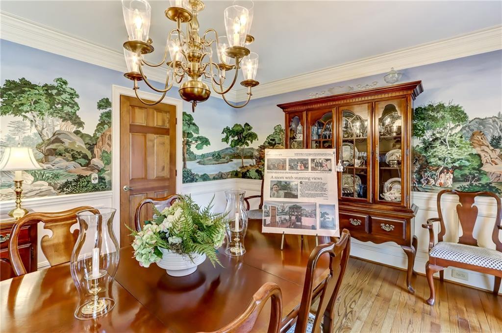 Dining space featuring a chandelier, ornamental molding, and light hardwood / wood-style floors