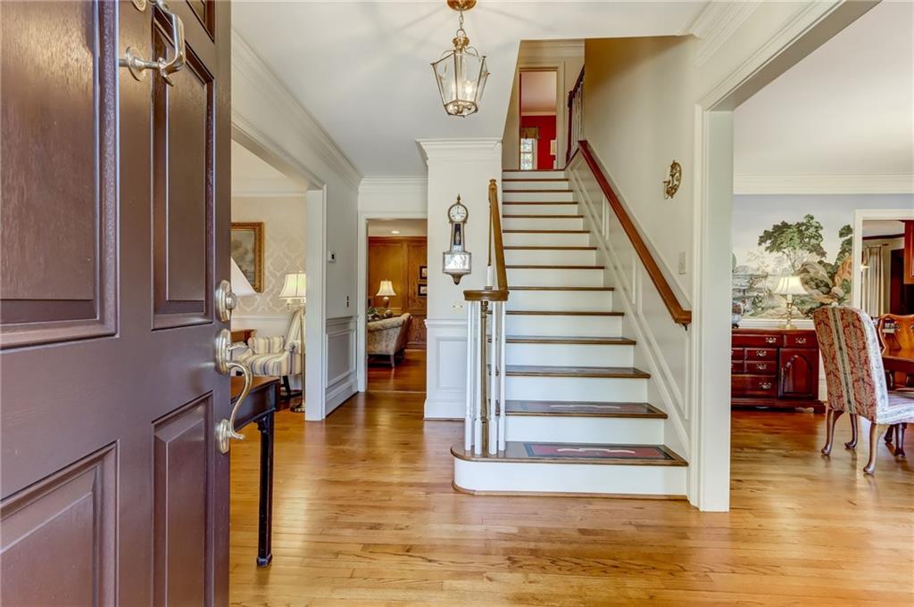 Foyer featuring a chandelier, light hardwood / wood-style floors, and crown molding