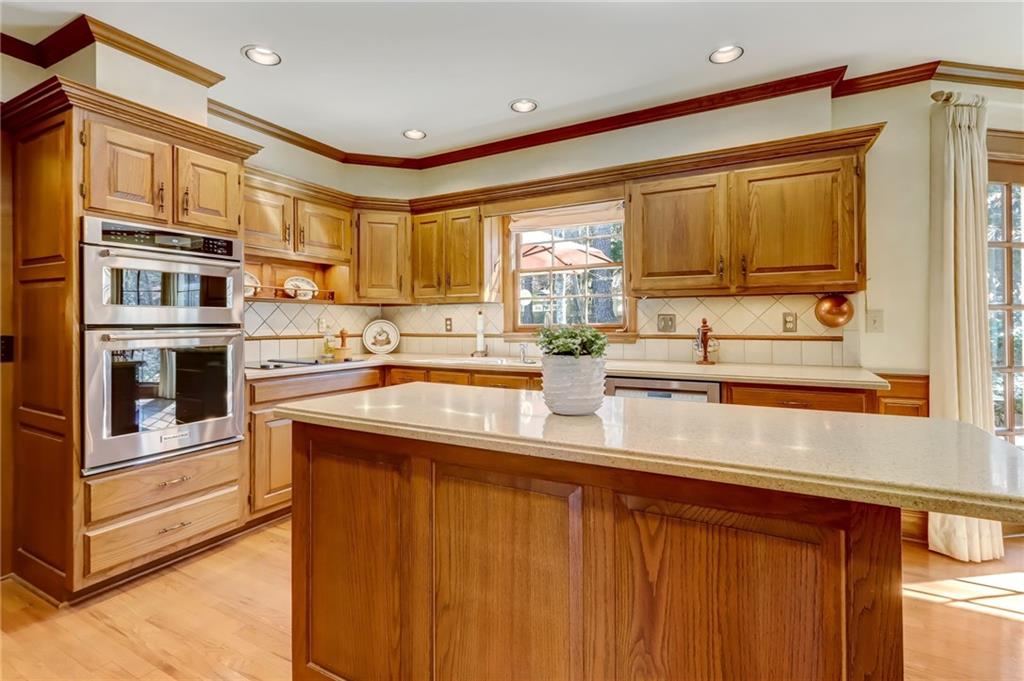 Interior details with tasteful backsplash, a bathing tub, and sink