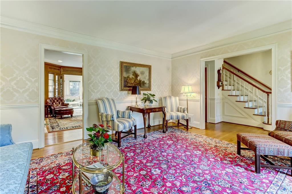 Sitting room with light hardwood / wood-style flooring and ornamental molding